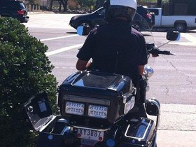 Police officer clocking people on University Dr an.jpg